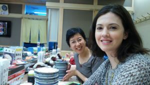 Figure 7. Yuki Bradford and Nicole Restrepo try to keep up with the sushi conveyor belt near the Kyoto convention center.