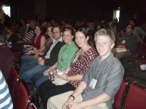 Figure 9. Graduate students listening attentively to a talk at the American Society of Human Genetics in San Diego, CA. Left to right: Kelli Ryckman, Logan Dumitrescu, Will Bush (!), Anna Davis (Cummings), Kylie Spencer, and Stephen Turner (2007).