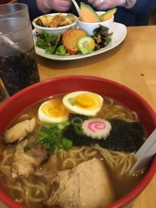 Figure 2. Regular ramen, with pork belly and egg in pork and chicken broth (foreground) and strata brunch special of the day (background).